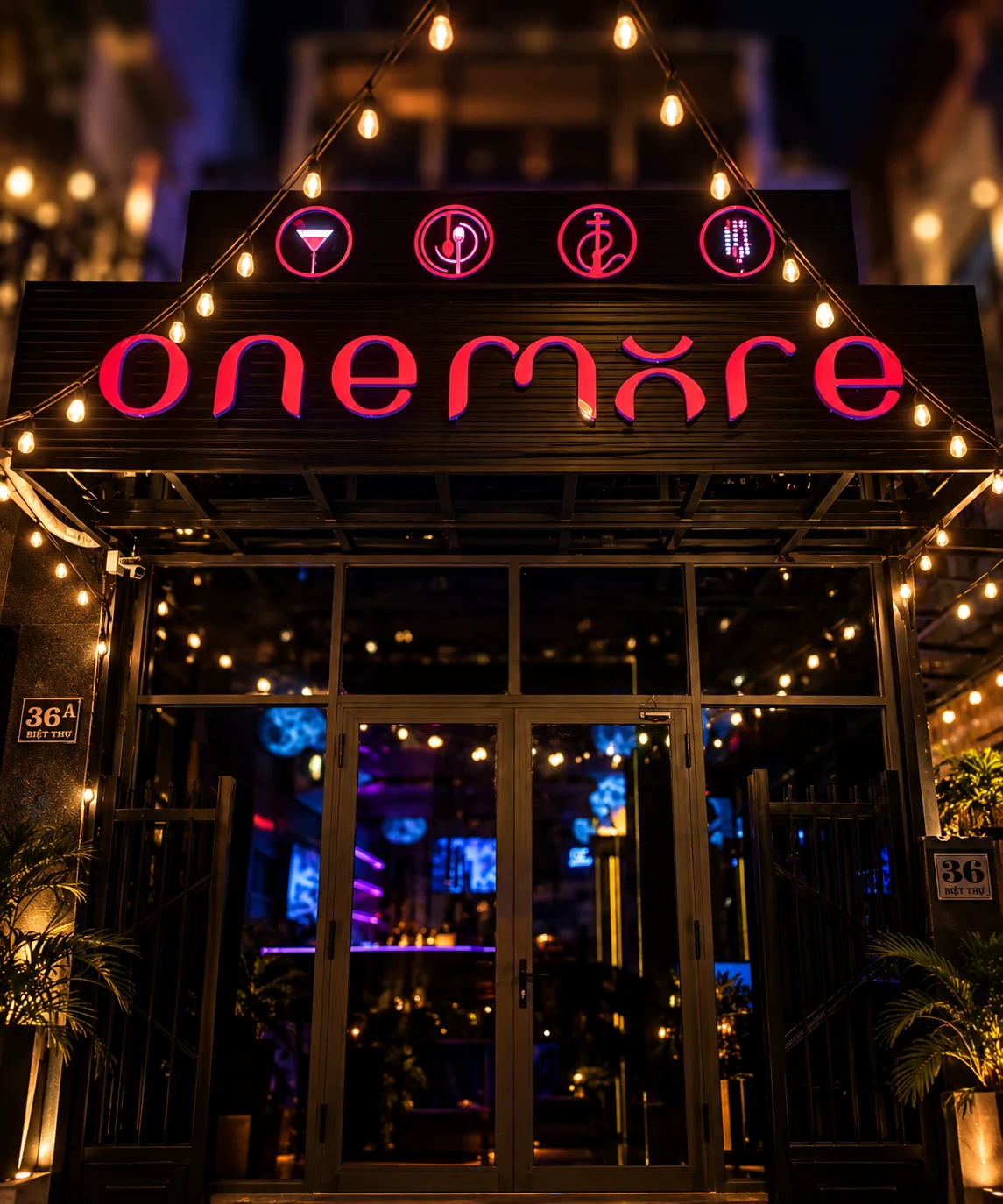 The red OneMore sign and entrance on Biệt Thự at night
